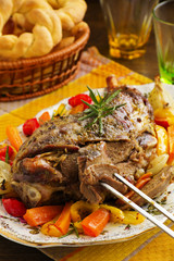 Roast leg of lamb with rosemary and garlic and vegetables.