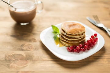 Pancakes with berries and maple syrup