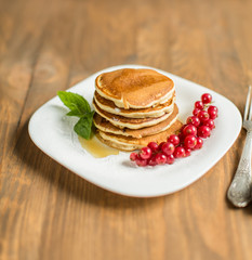 Pancakes with berries and maple syrup