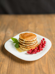Pancakes with berries and maple syrup