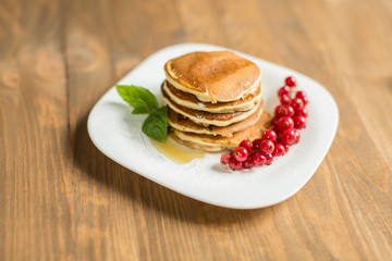 Pancakes with berries and maple syrup
