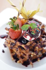 Chocolate Waffle topped with ice cream and strawberry