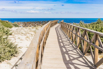Fototapeta na wymiar Holzsteg zum Strand Platja de Muro Alcudia Mallorca
