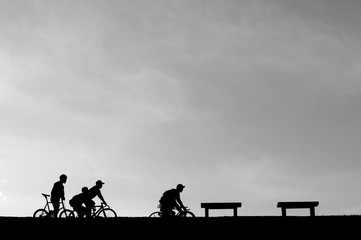 Fototapeta na wymiar The silhouette of people cycling 