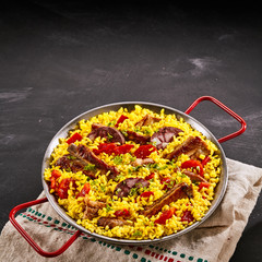Paella al homo with black pudding and spare ribs