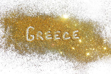 Inscription Greece on golden glitter sparkle on white background