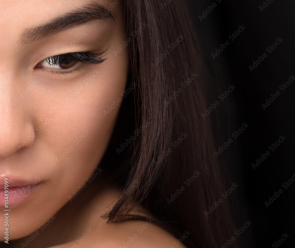 Wall mural half face of asian lady in studio