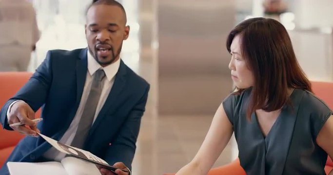 Multi-Ethnic Business people working in business lobby