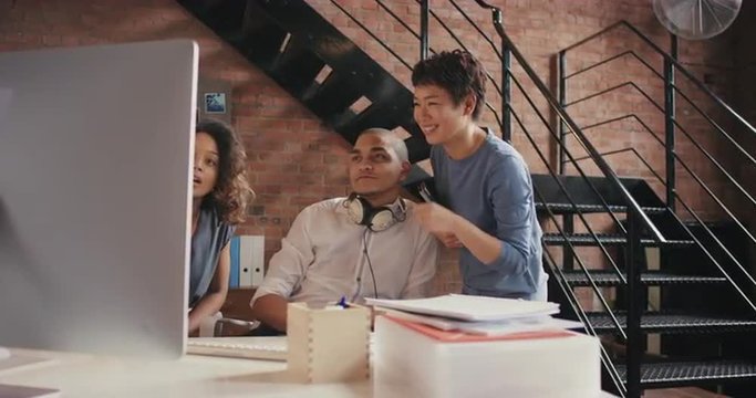 Asian software engineer offering advice to male designer businessman