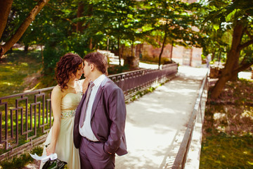 Happy newlywed romantic couple walking in the park