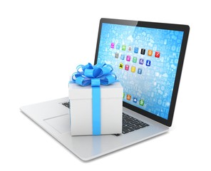 Gift box with ribbon bow on laptop keyboard