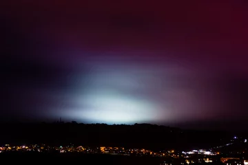 Foto auf Acrylglas Light pollution from sports fields. A rainy night shows light from university pitches at night, above the City of Bath, UK © iredding01