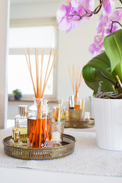 Aroma reed diffuser  in home interior. Selective focus on bottle and sticks.