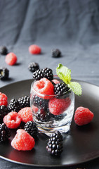 black berries and raspberries in a glass cup