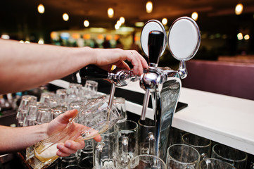 Close up of barman hand at beer tap