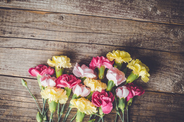 Carnation flowers on wooden table