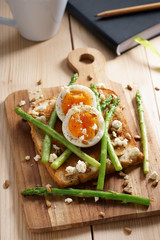 breakfast toast top with asparagus and soft boiled egg