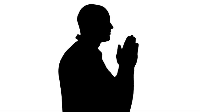 The man who is prays on a white background.