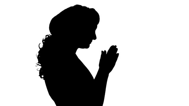 The woman who is prays on a white background.