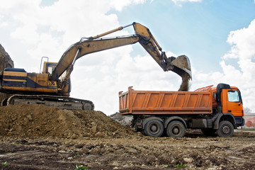 Excavator loading truck - Powered by Adobe