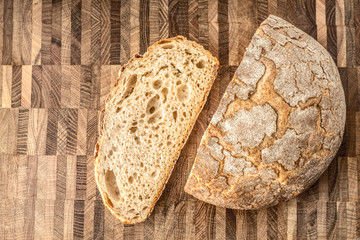 Half of rye bread and a piece on the table