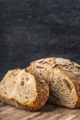 Half of rye bread and a piece on the table