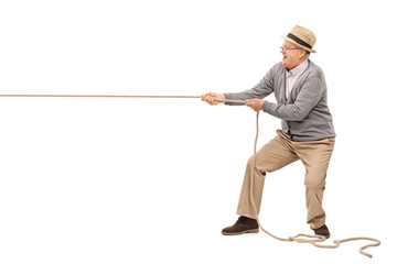 Cheerful senior pulling a rope