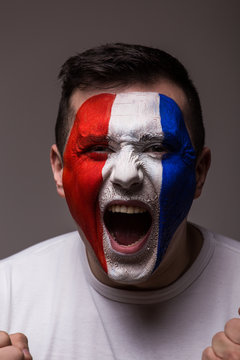 Portrait Euphoric scream of France football fan in win game of France national  team  on grey background. UEFA EURO 2016 football fans concept.