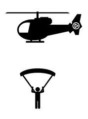 Parachutiste sous un hélicoptère