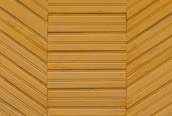 Yellow painted wooden wall texture.