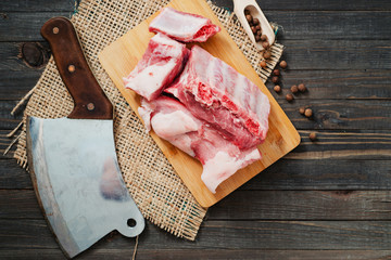 raw meat , pork ribs with spices on a wooden board