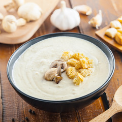 Delicious mushroom cream soup is cooking for lunch, ingredients on a table, European French food