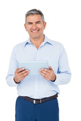 Smiling businessman using tablet