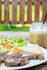Grilled steak with fresh vegetables and ice coffee