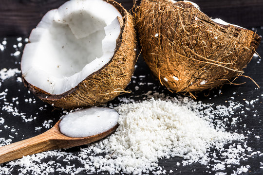 Fresh coconut and coconut oil on wooden spoon