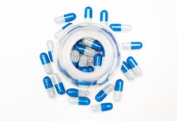 vitamin pills around and inside container