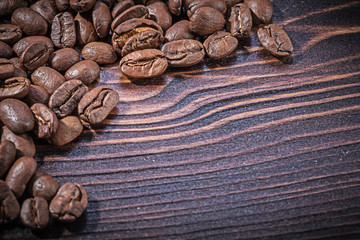 Stack of coffee beans on vintage wooden board