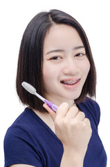 Young Asian girl with teeth brace over white background