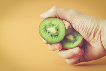 Hand holding kiwifruit