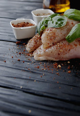 raw chicken breasts with herbs spices
