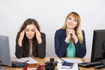 The situation in the office - from one girl really a headache, the other looks happy in the picture
