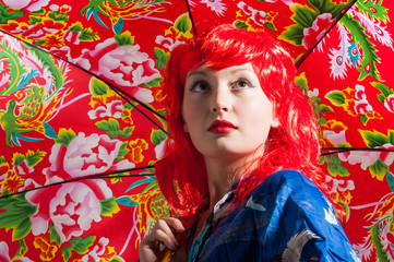 young lady with red hair and colorful umbrella
