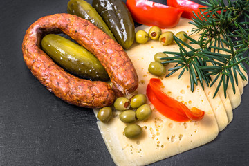 Ingredients of breakfast with cheese slices, sausage and vegetab