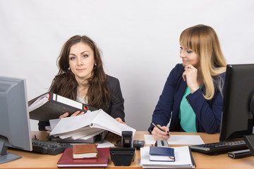 The situation in the office - one employee inundated with work and looking at the frame, the other...