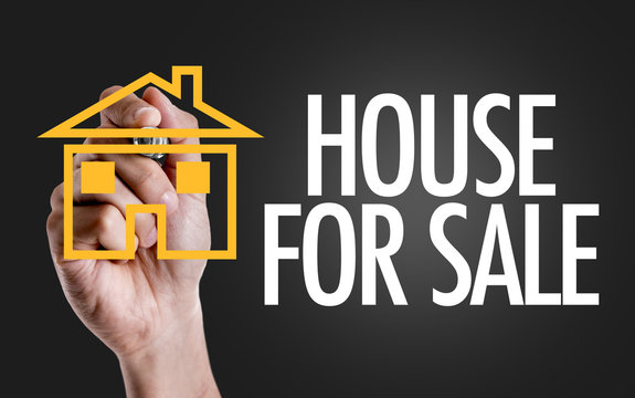Hand writing the text: House For Sale