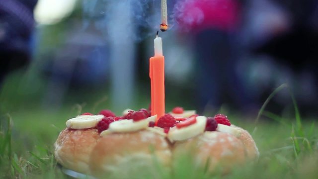 lit candle in the shape of figure one in the park celebrating the first year of birthday with cake. 1920x1080