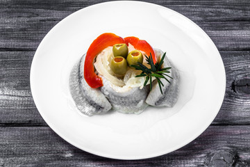 Marinated herrings on white plate