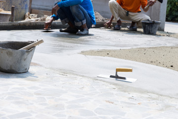 workers plaster concrete