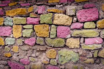 Rainbow painted stone wall texture background.