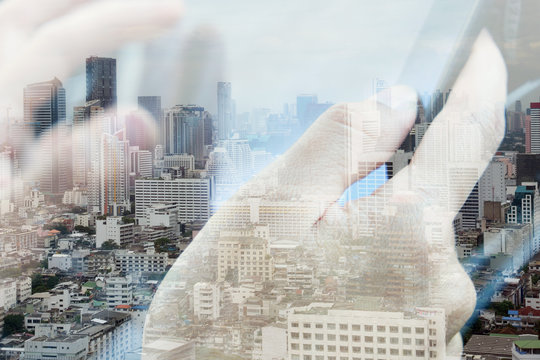 concept image of Business & technology,Abstract image of Using digital tablet double exposure and and cityscape background.